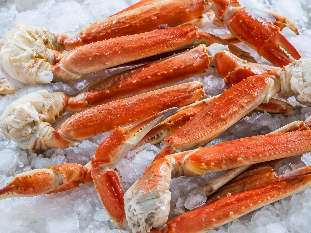 Frozen cooked snow crab sections on ice